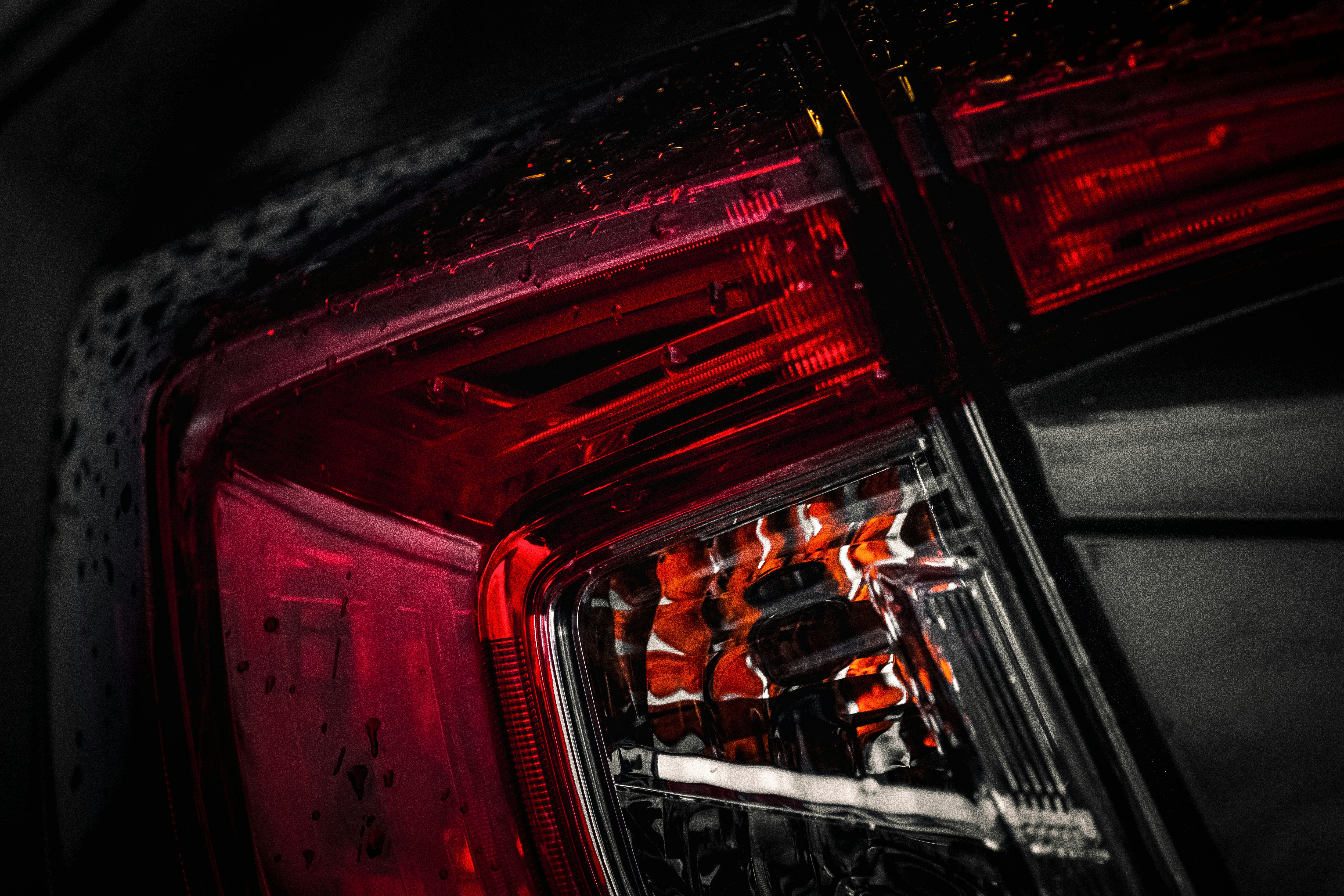 red and black car in the city during night time